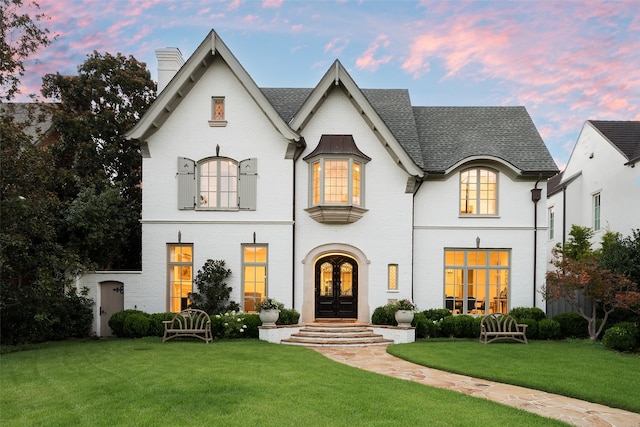 french country style house with a yard