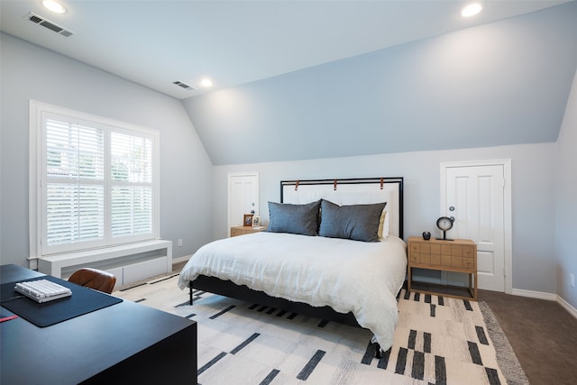 bedroom featuring light carpet and lofted ceiling