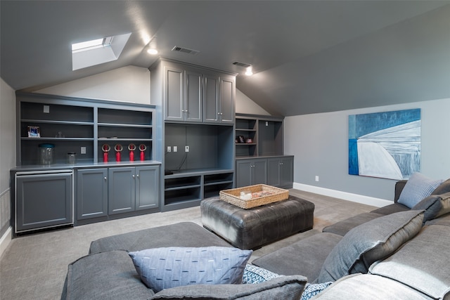 living room with carpet flooring, built in shelves, and lofted ceiling with skylight