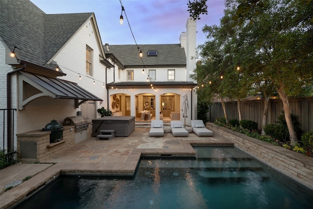 back house at dusk featuring a patio area, area for grilling, and a fenced in pool