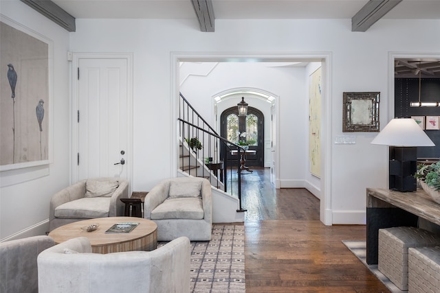 living room with beam ceiling and wood-type flooring