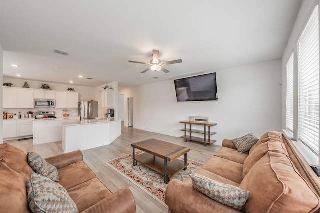 living area with visible vents, recessed lighting, a ceiling fan, and plenty of natural light