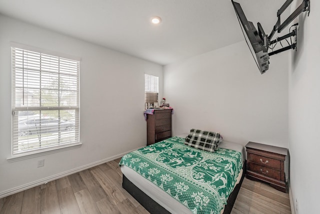 bedroom featuring baseboards and wood finished floors