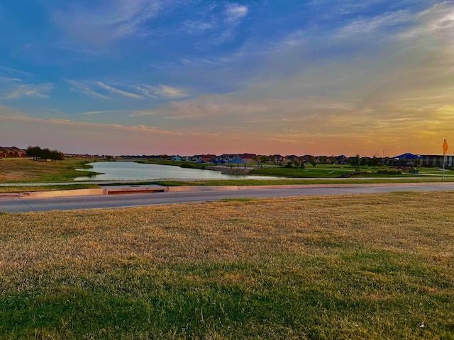 view of home's community featuring a yard and a water view