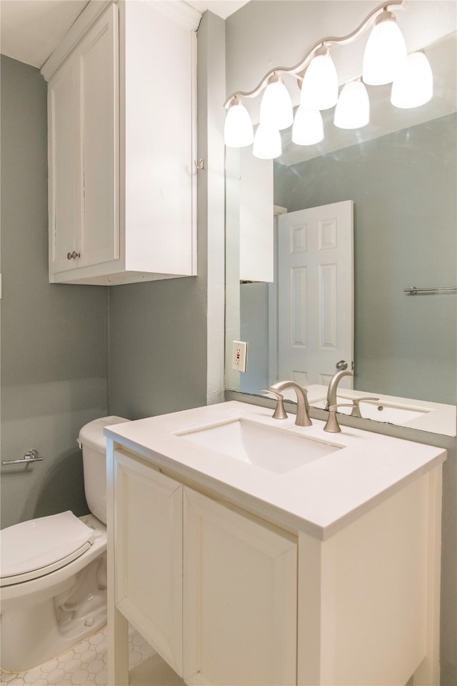 bathroom with tile patterned flooring, toilet, and vanity