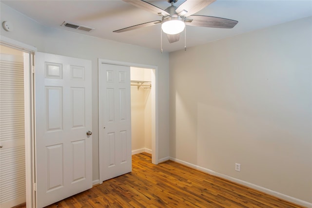 unfurnished bedroom with ceiling fan and hardwood / wood-style floors