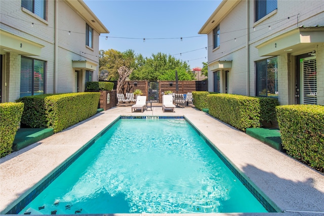 view of swimming pool featuring a patio area