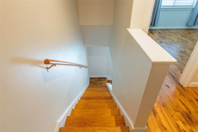 staircase featuring hardwood / wood-style flooring