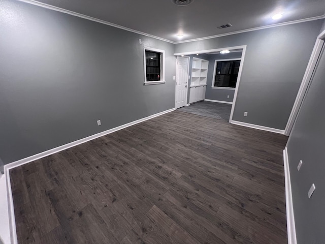 spare room with dark hardwood / wood-style floors and ornamental molding