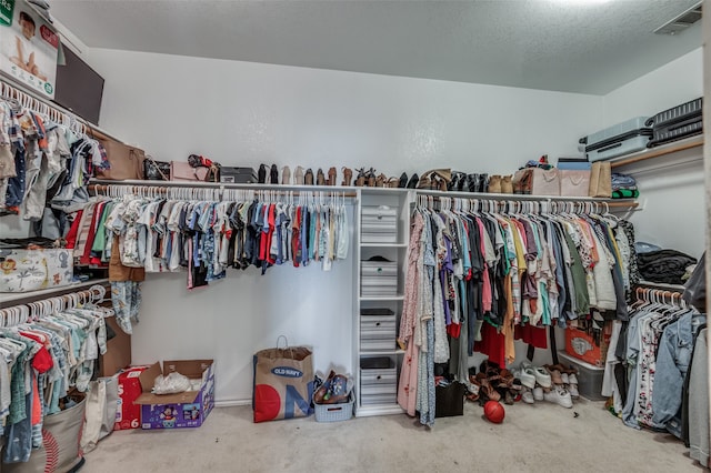 walk in closet featuring carpet flooring