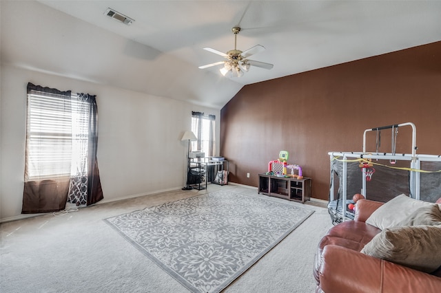 interior space with ceiling fan, vaulted ceiling, and carpet