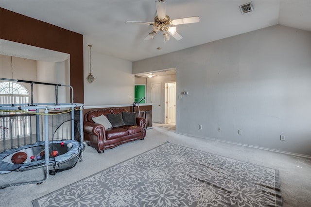 carpeted living room with ceiling fan and lofted ceiling