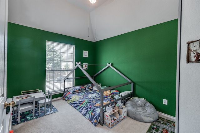 bedroom with carpet and lofted ceiling