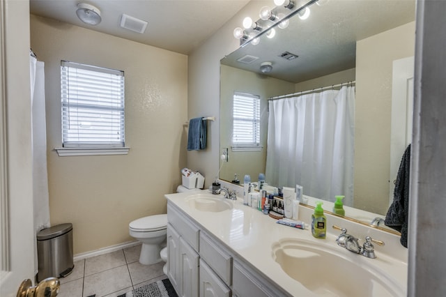 bathroom featuring tile patterned flooring, dual vanity, and toilet