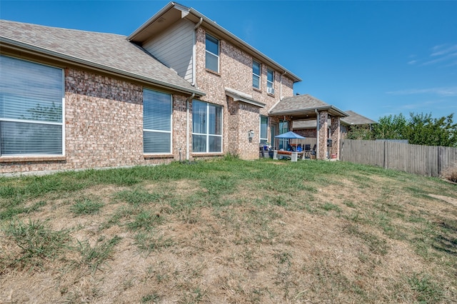 back of house with a lawn