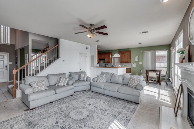 living room with ceiling fan and light tile patterned floors