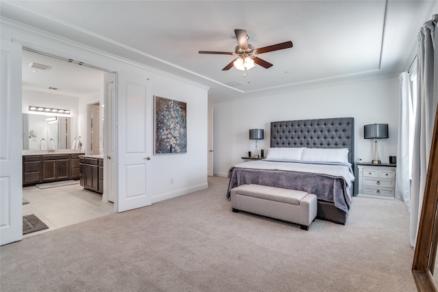 bedroom featuring connected bathroom, ornamental molding, light colored carpet, and ceiling fan