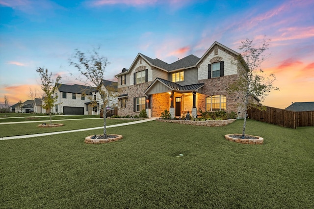 view of front of house featuring an outdoor fire pit, a lawn, and a garage