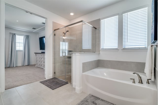 bathroom with a wealth of natural light, tile patterned floors, and shower with separate bathtub