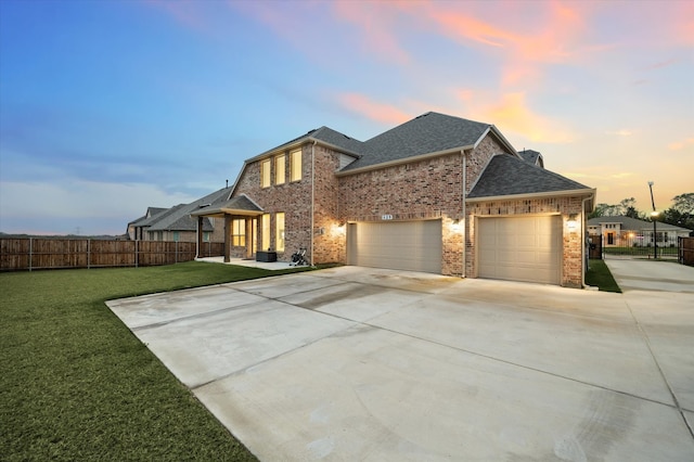 view of front of home with a garage and a yard