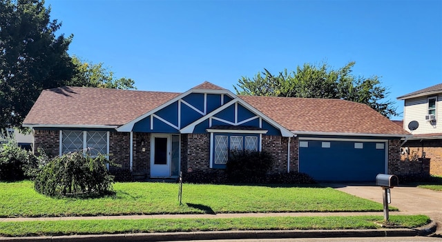 view of front of property featuring a garage and a front lawn