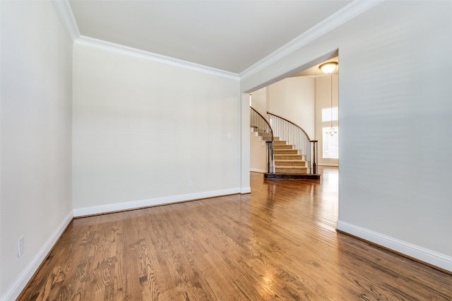 spare room featuring ornamental molding and wood-type flooring