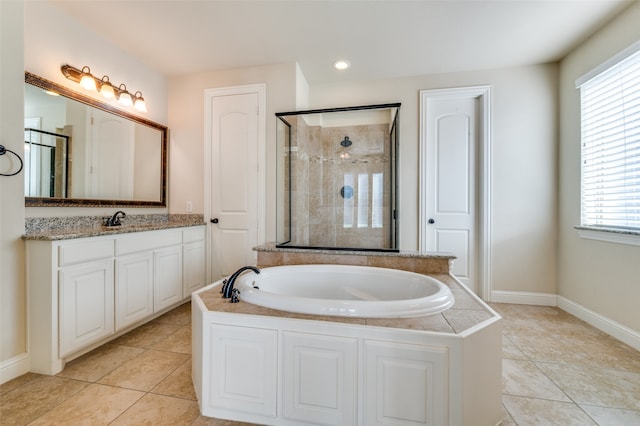 bathroom with independent shower and bath, tile patterned floors, and vanity