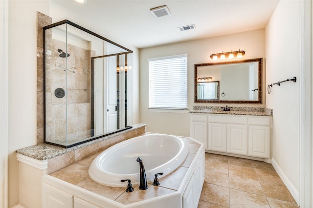 bathroom with plus walk in shower, tile patterned flooring, and vanity