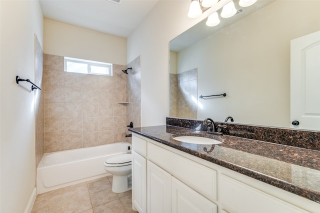 full bathroom with tile patterned flooring, vanity, tiled shower / bath combo, and toilet