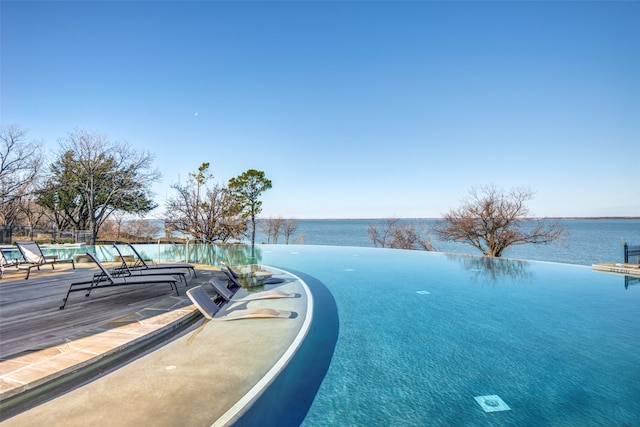 view of swimming pool featuring a water view