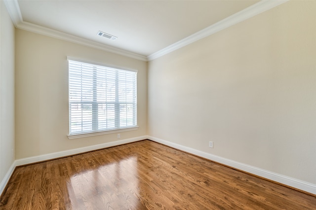 unfurnished room featuring hardwood / wood-style flooring and ornamental molding