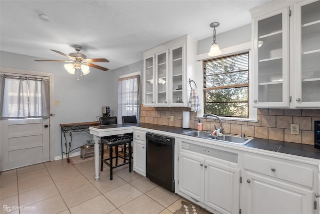 kitchen featuring white cabinetry, sink, and black dishwasher