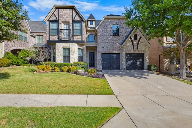 view of front of home featuring a garage, a front lawn, and a balcony