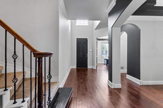 entrance foyer with ornamental molding and hardwood / wood-style flooring