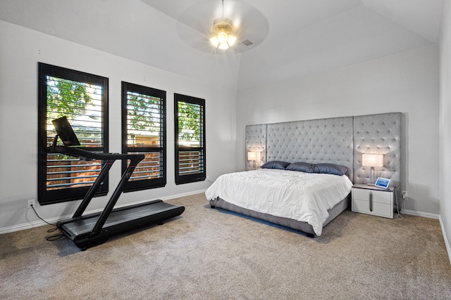 carpeted bedroom with ceiling fan and vaulted ceiling