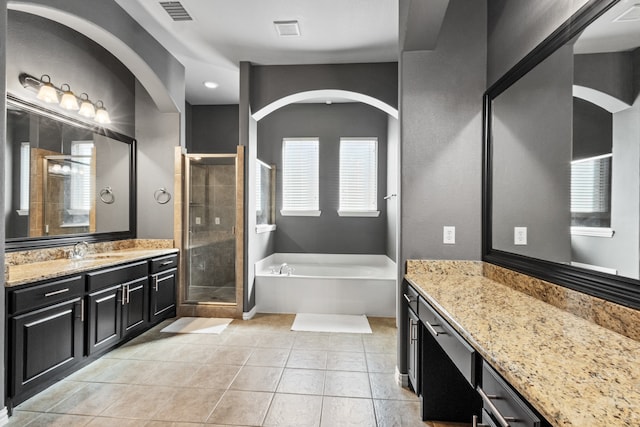 bathroom featuring tile patterned flooring, vanity, and independent shower and bath