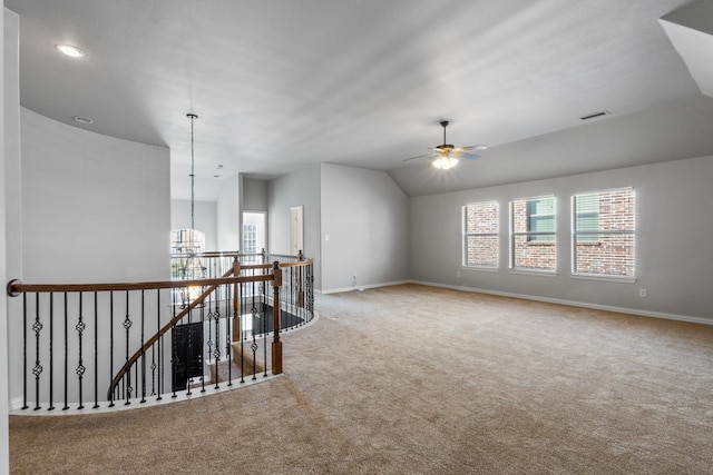 carpeted empty room featuring ceiling fan and vaulted ceiling