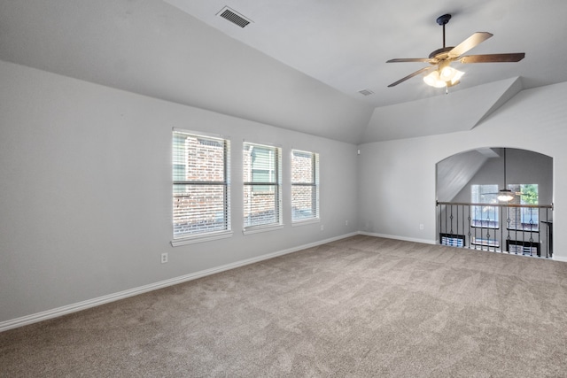 carpeted empty room featuring ceiling fan and lofted ceiling