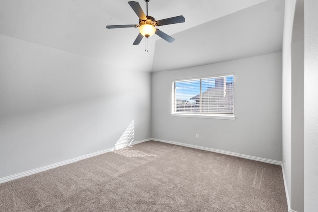 empty room featuring ceiling fan, carpet, and lofted ceiling