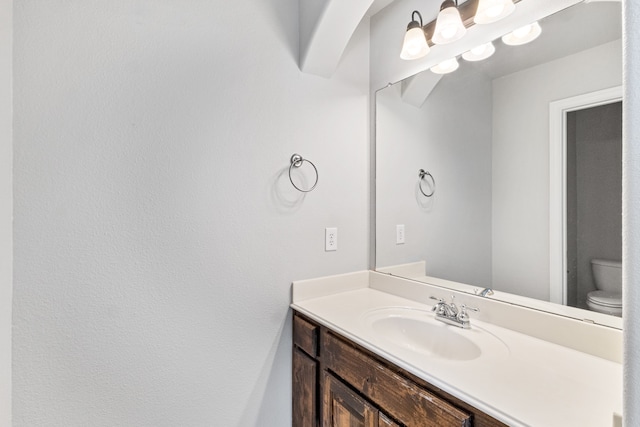 bathroom with toilet and vanity