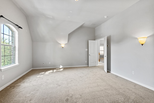 bonus room with carpet floors and lofted ceiling