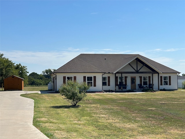 view of front facade featuring a front lawn and an outbuilding