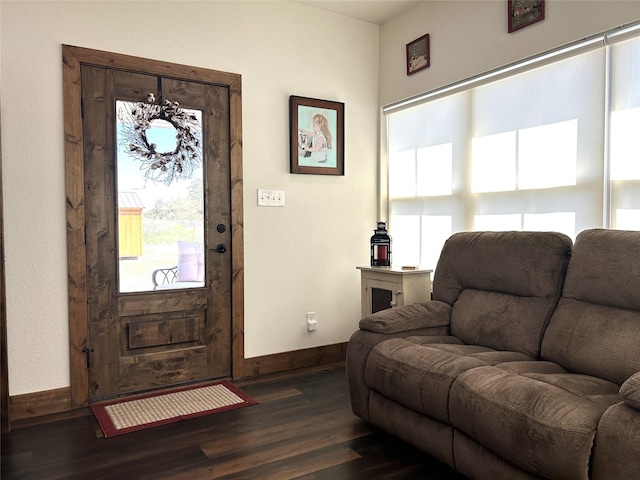 foyer entrance featuring dark wood-style floors and baseboards