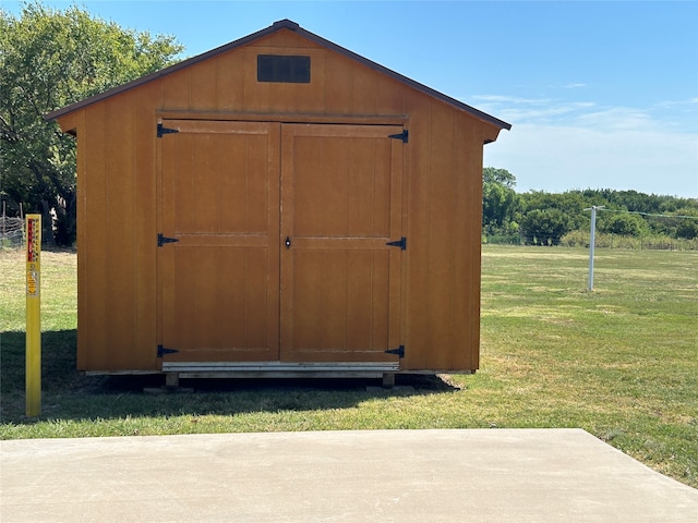 view of outbuilding with a lawn