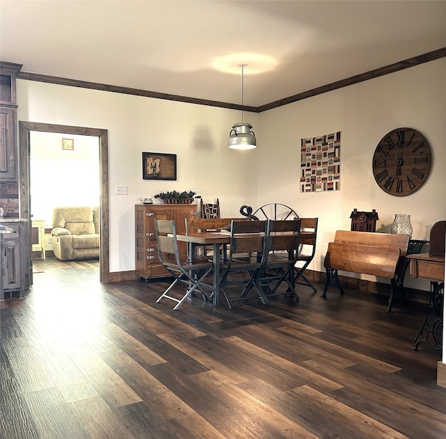 dining room featuring crown molding and dark hardwood / wood-style floors