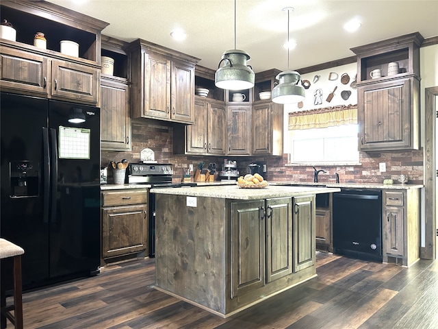 kitchen featuring a center island, ornamental molding, dark hardwood / wood-style flooring, dark brown cabinetry, and black appliances