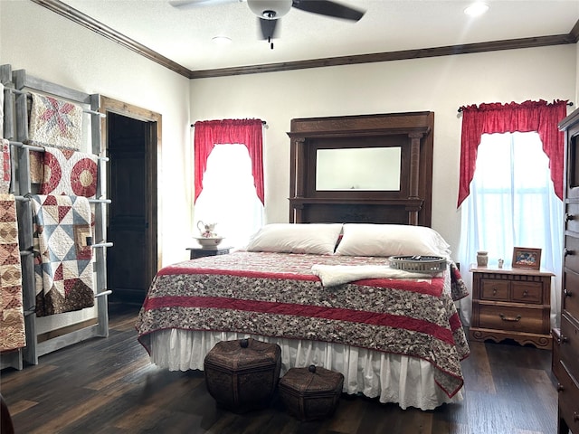 bedroom with dark wood-type flooring, crown molding, and ceiling fan