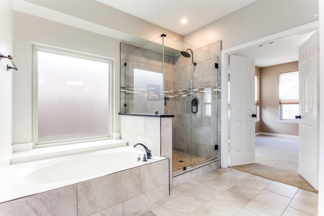 bathroom featuring independent shower and bath