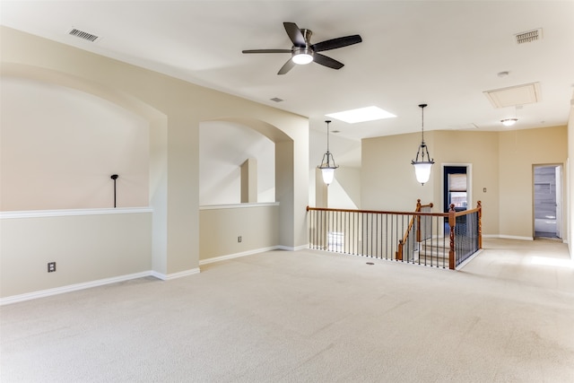 carpeted empty room featuring ceiling fan