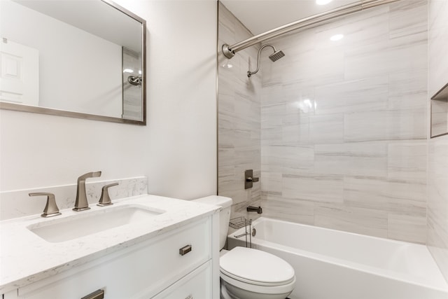 full bathroom with vanity, tiled shower / bath combo, and toilet